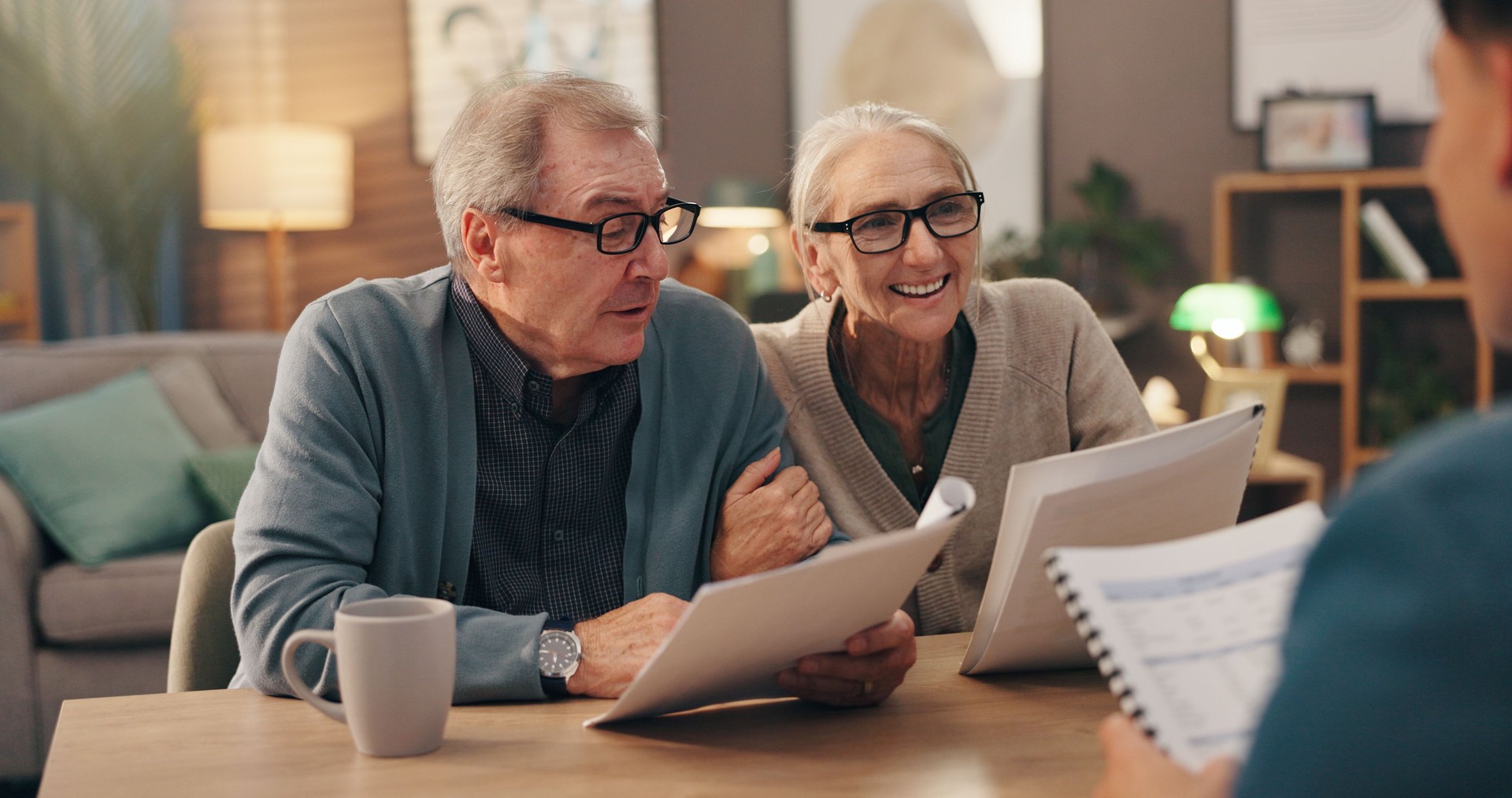 Elderly couple, documents and financial advisor with retirement plan for asset management at house. Senior man, woman and paperwork with accountant for pension fund or application at old age home